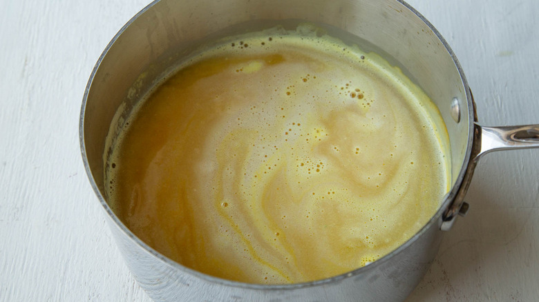 saucepan with water, rice, and turmeric