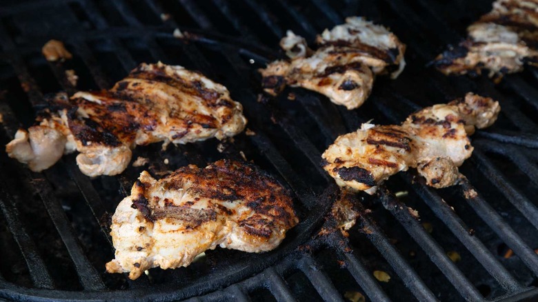 grilled chicken thighs cooking on grill