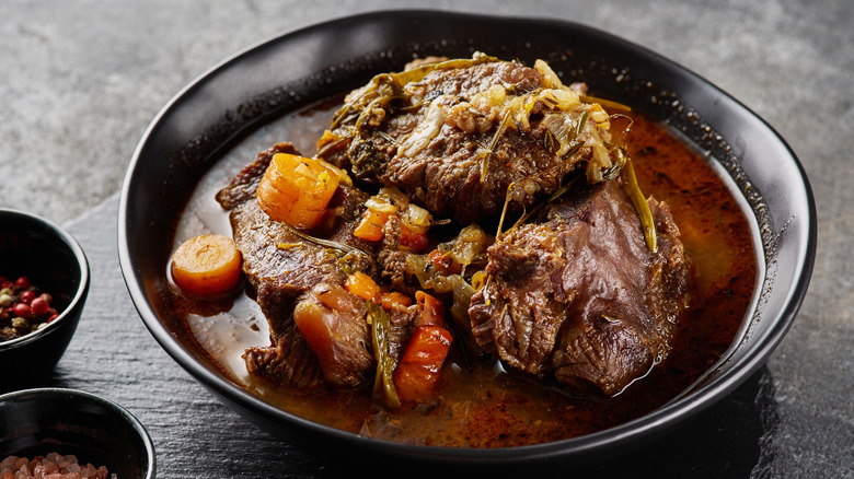 Pot roast served on a black plate