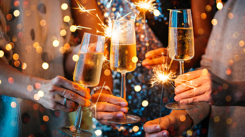 Friends cheers champagne on NYE.