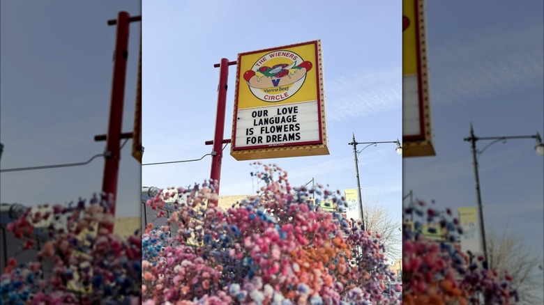 The Wieners Circle exterior sign with flowers