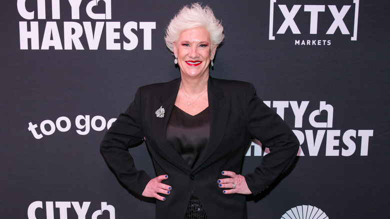 Anne Burrell at an event for City Harvest in a black ensemble with her signature spiky blonde hair
