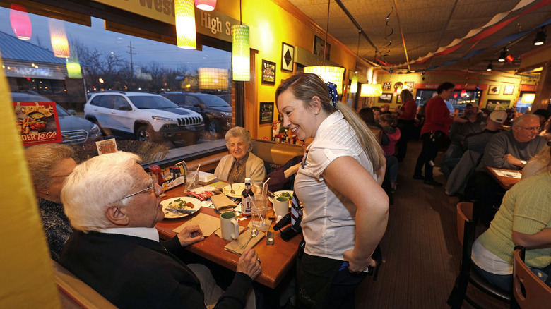 Applebee's server greeting customers
