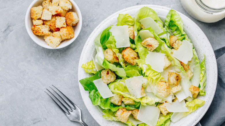 Caesar salad on white plate with crutons