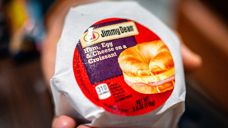 A wrapped Jimmy Dean ham, egg, and cheese on a croissant breakfast sandwich