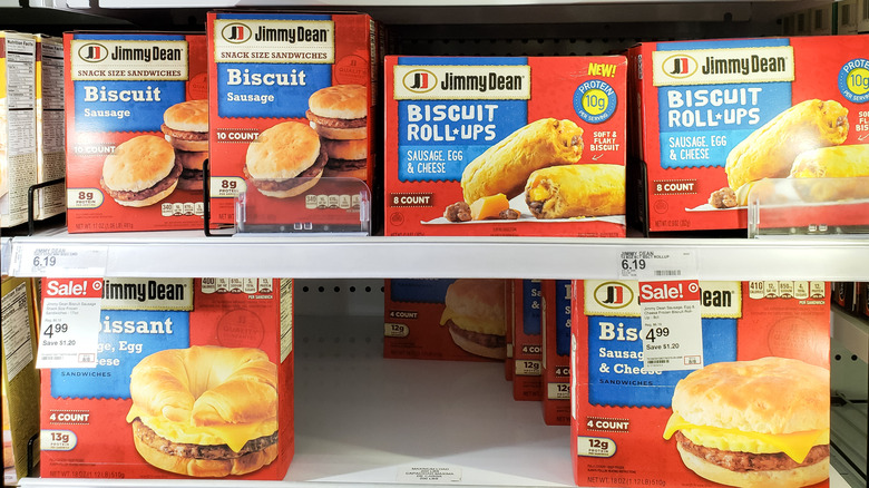 A grocery store freezer filled with boxes of Jimmy Dean breakfast products, mostly sandwiches
