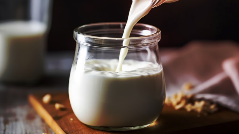 Buttermilk pouring into glass jar