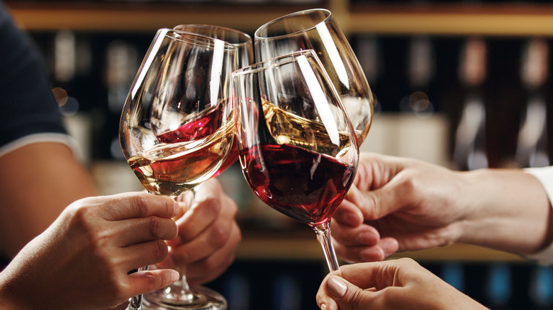 People clinking glasses of wine in a toast