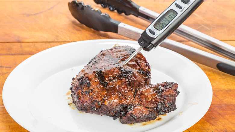 testing steak with a meat thermometer
