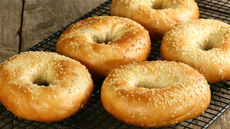 Sesame seed bagels on a cooling tray