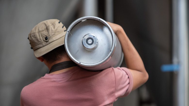 Person carrying a pony keg of beer