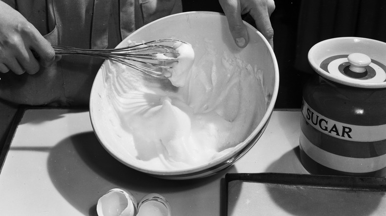 woman whisking egg in bowl