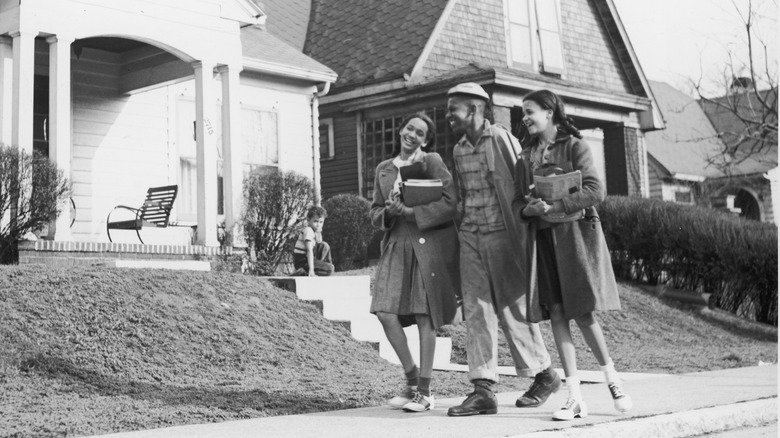 three young adults walking down street