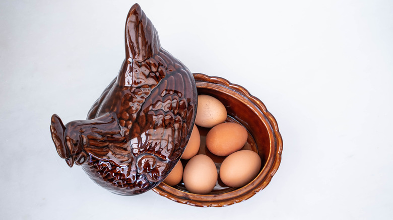 wooden chicken holding eggs