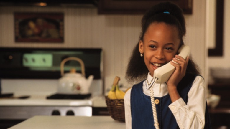 90s child speaking on phone