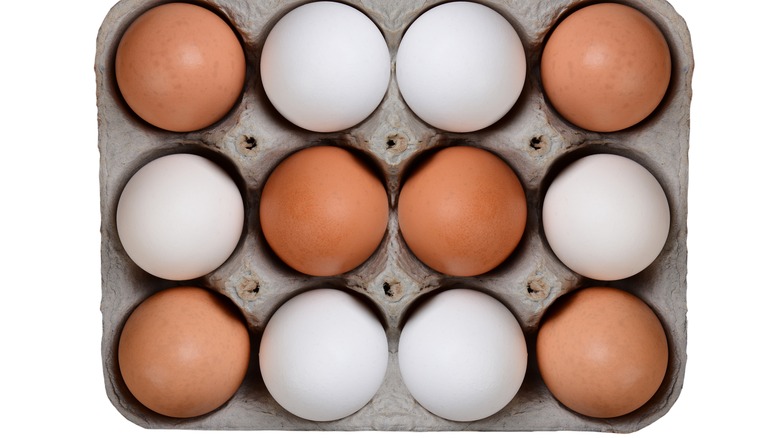 Brown and white eggs carton