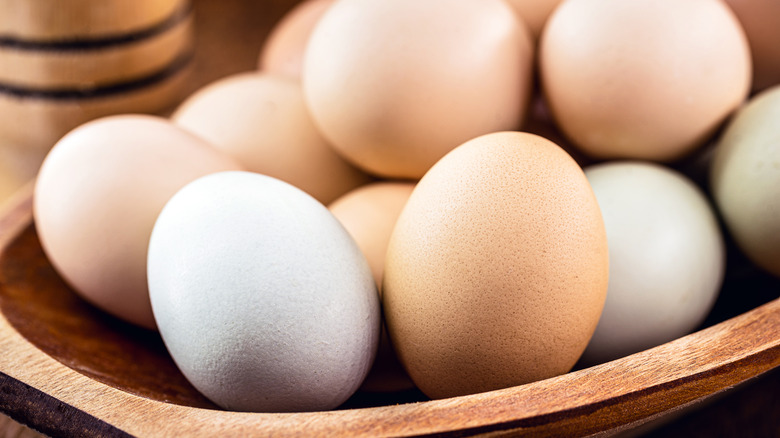 Brown and white eggs in bowl