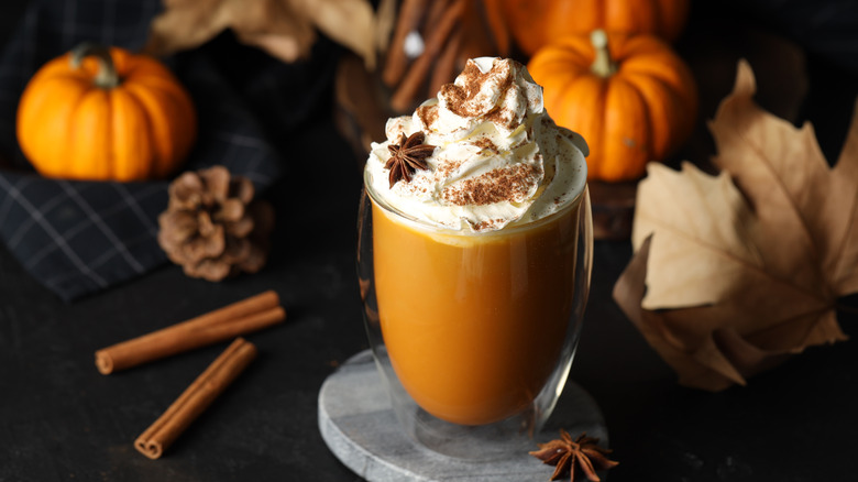 Pumpkin spice latte with pumpkins and cinnamon