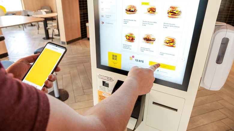 Person orders at self service machine in McDonald's