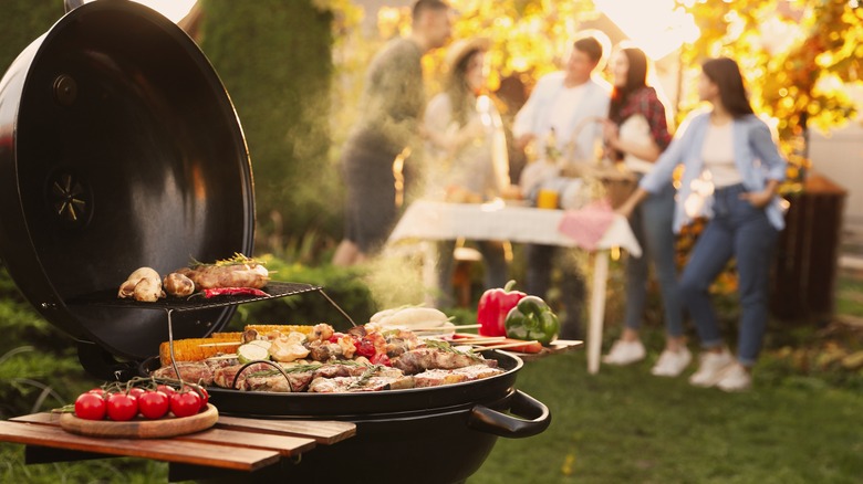 Food on grill with people in background