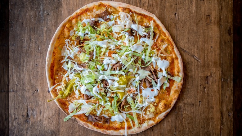The famous Swedish kebab pizza, topped with green fefferoni peppers and creamy garlic sauce