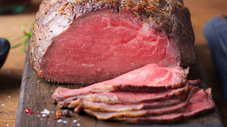 Sliced roast beef on cutting board