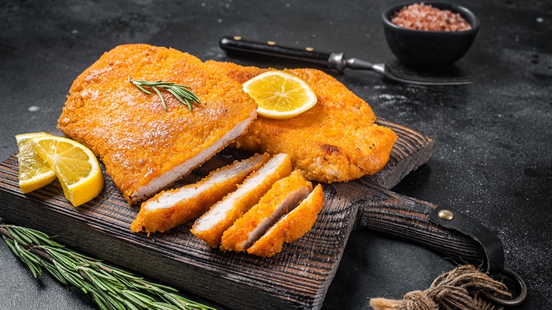 Wiener schnitzel on a wooden cutting board