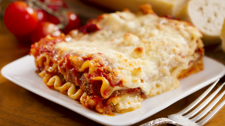 Large slice of lasagna on white plate