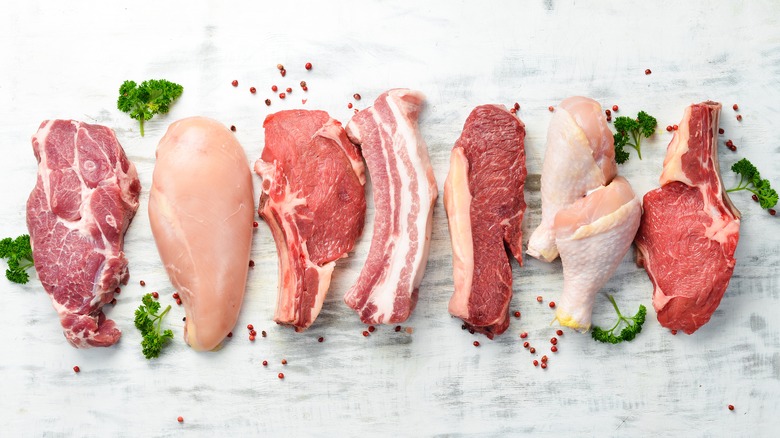 Types of raw meat on white background