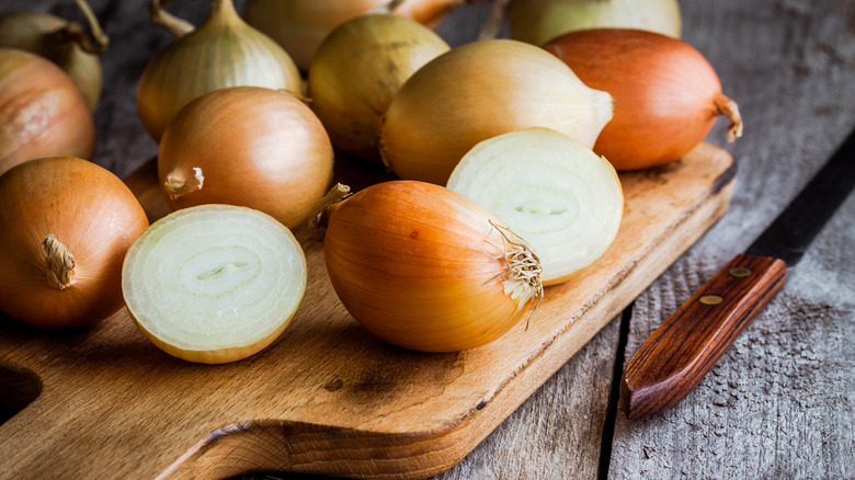Halved onions on cutting board