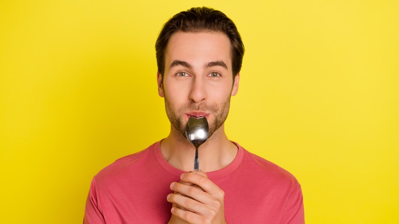 Man with spoon in his mouth