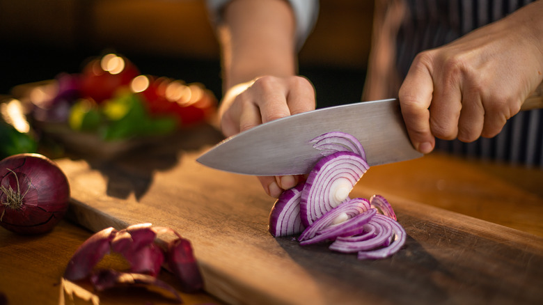 Sharp knife cutting onion
