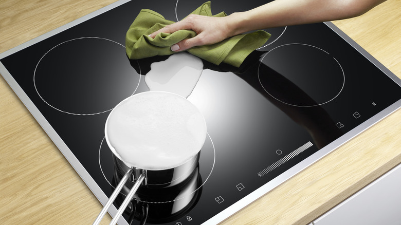 Woman cleaning an electric stove