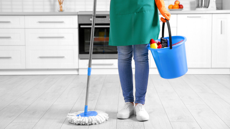 Person with bucket and mop