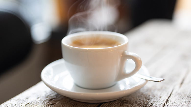 Steaming coffee porcelain cup