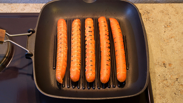 hot dogs on a griddle