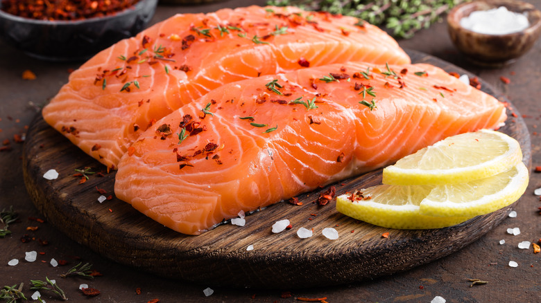 Raw salmon filets on board
