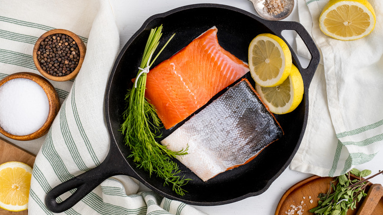 Salmon skin-on in pan with garnish