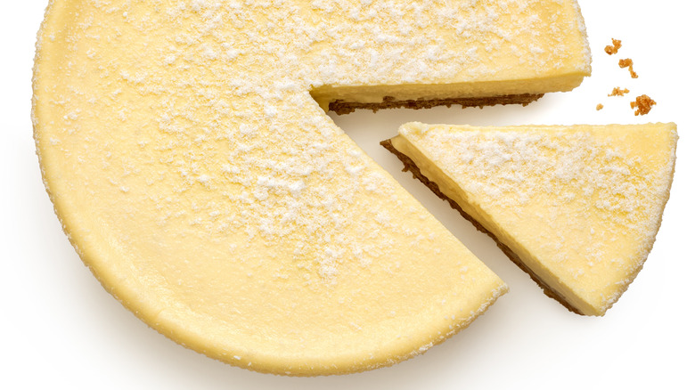 slice of cheesecake cut from whole cake
