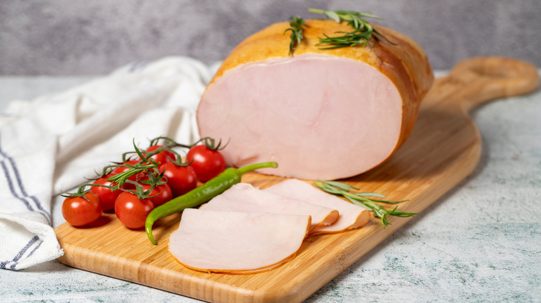 Smoked turkey meat on a wooden board.