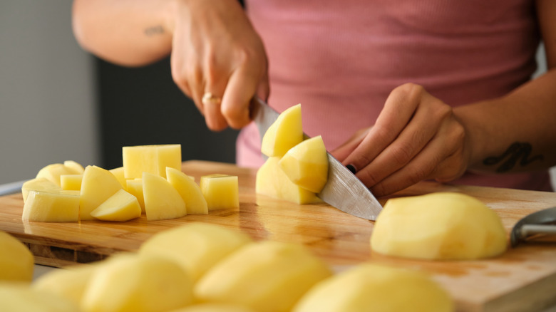 Person cutting potatoes