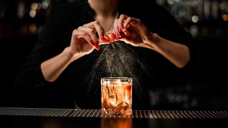 Bartender expressing orange peel