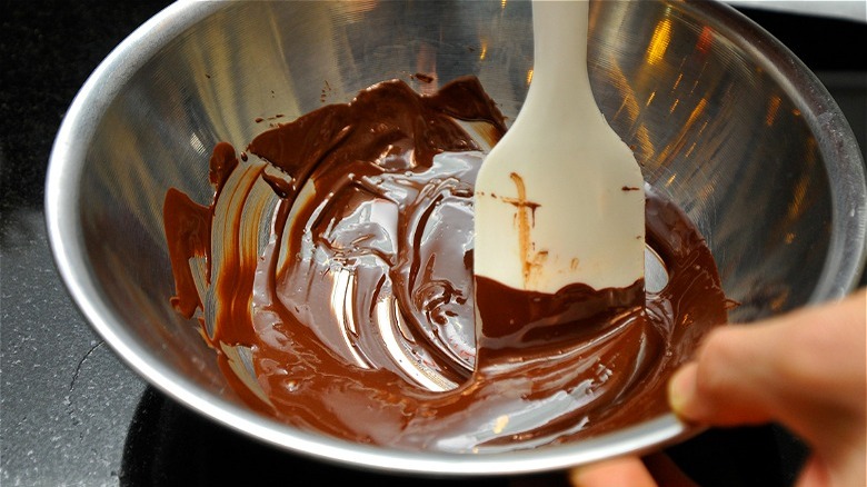 Melted chocolate in bowl with spatula