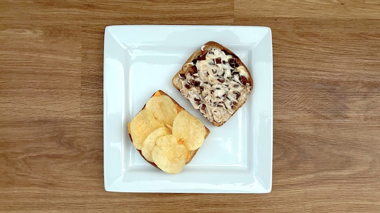 Assembling the Branston pickle and cheese sandwich on a square white plate