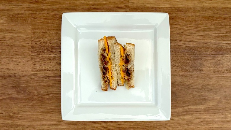 Branston pickle and cheese sandwich on a square white plate