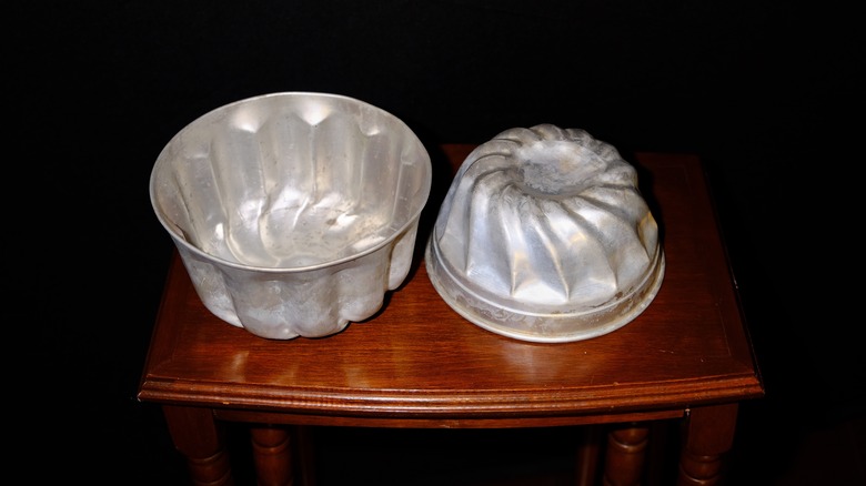 Metal Jell-O molds on a wooden table