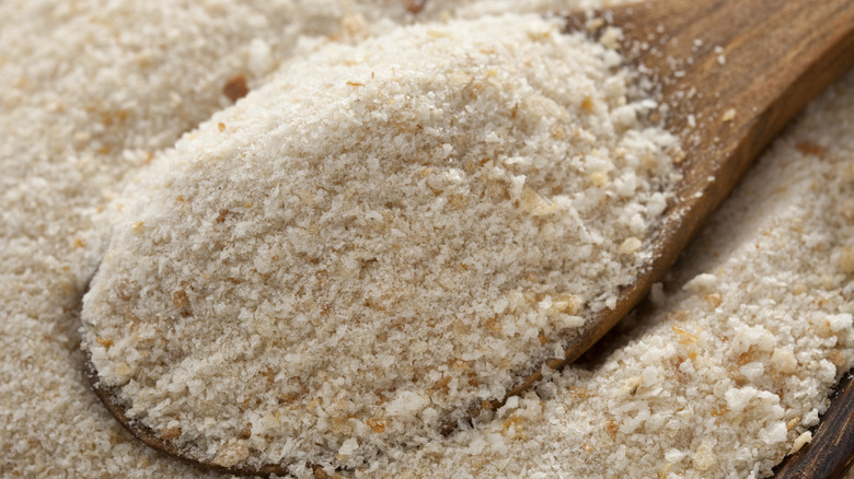 Wooden spoon in pile of breadcrumbs