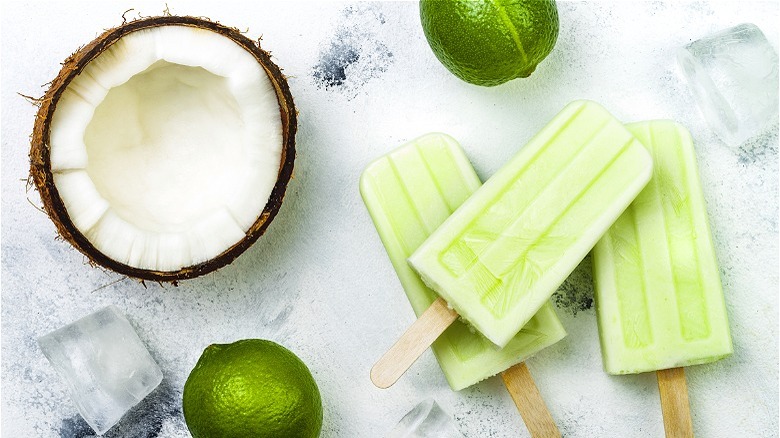 Green popsicles next to coconut