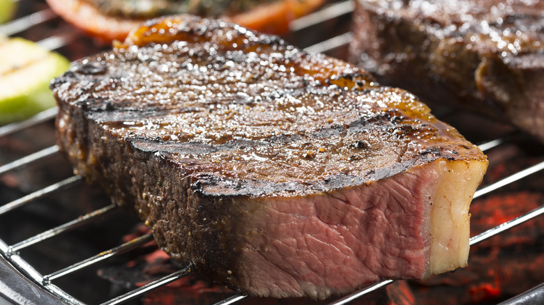 Large steak on grill