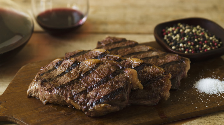 Three steaks on cutting board